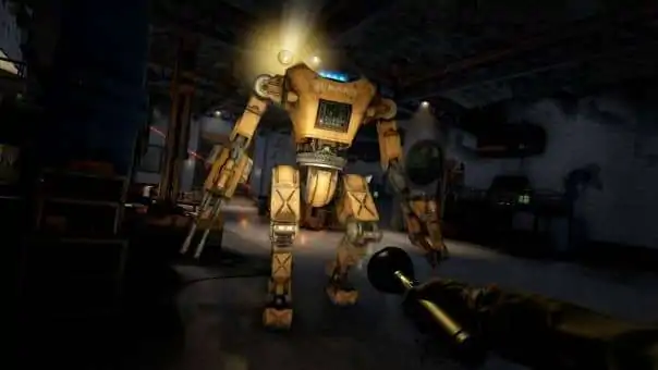 Facing a BARD robot attack in a dark hangar with only a torch for light during the Atomfall review, highlighting intense gameplay.