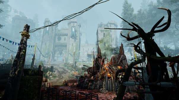 A makeshift druid camp with the remains of a castle in the background during the Atomfall review, highlighting the mysterious setting.