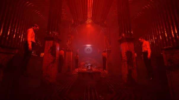 Karma: The Dark World Review image featuring a mysterious red-lit room where figures stand eerily still, almost floating, evoking psychological tension.