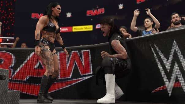 Rhea Ripley taunts an injured Dominik Mysterio in WWE 2K25 Bloodline Edition review, showcasing intense storytelling and dynamic in-ring action.