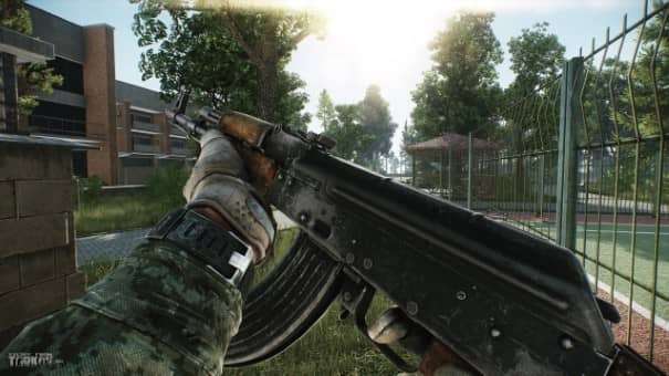A character closely inspecting an AK-47 in the Escape from Tarkov review, showcasing its detailed weapon mechanics.