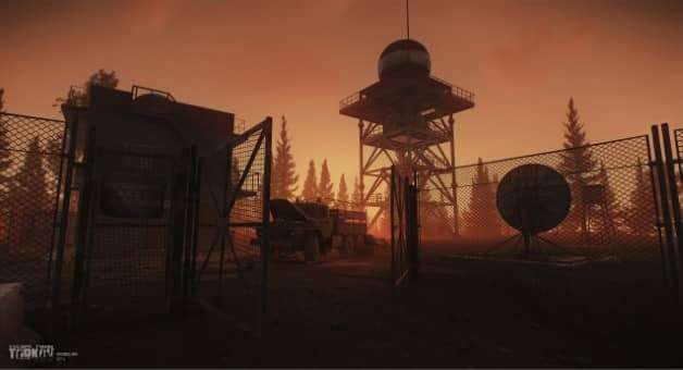 A stunning sunrise over the barracks in the Escape from Tarkov review, highlighting the game's immersive lighting.