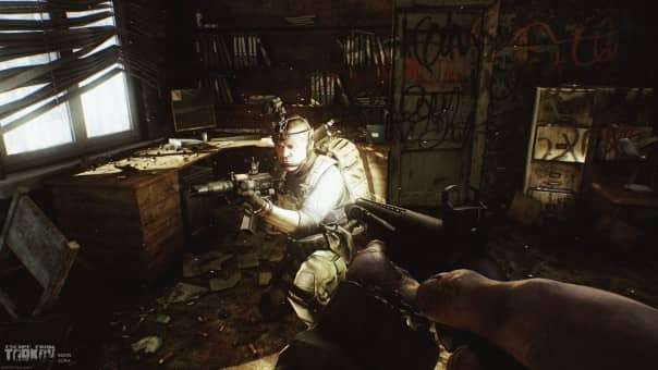 A character spots a teammate hiding near office buildings in the Escape from Tarkov review, emphasizing tactical positioning.