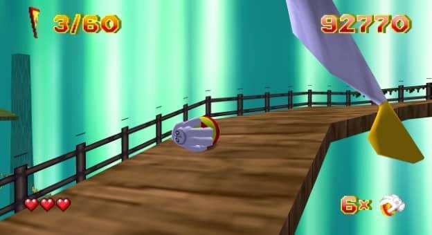 Glover (QUByte Classics) review – Carefully pushing the ball up a wooden bridge, navigating tricky platforms and mastering precise movements.