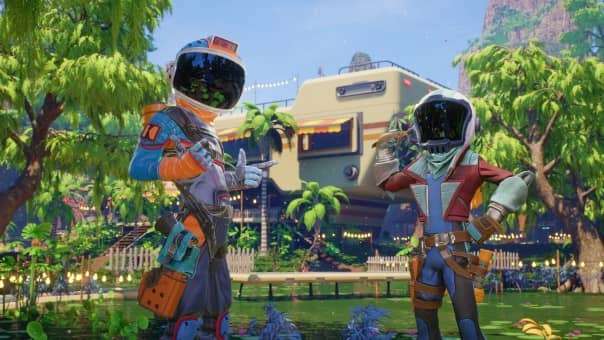 The two main characters striking a pose outside their caravan-style home base in the Revenge of the Savage Planet review.