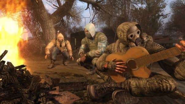 A group of soldiers enjoying downtime in the S.T.A.L.K.E.R.: Legends of the Zone Trilogy review, playing guitar around a campfire.