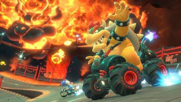 Bowser stands near an erupting volcano in the Mario Kart World review, adding intensity to the explosive setting.