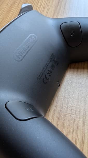 A close-up of the GL and GR additional buttons on the back of the Nintendo Switch 2 Pro Controller, featured in our review.