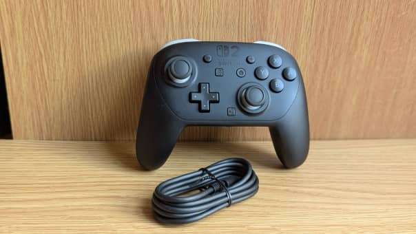 The Nintendo Switch 2 Pro Controller standing upright, showcasing its charge cable connection in our review