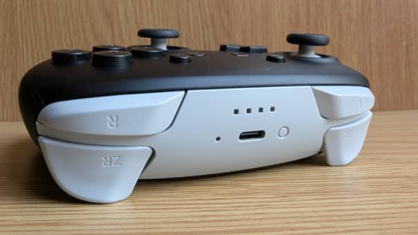 A close-up of the top of the Nintendo Switch 2 Pro Controller, showcasing its LED lights and charging port in our review.