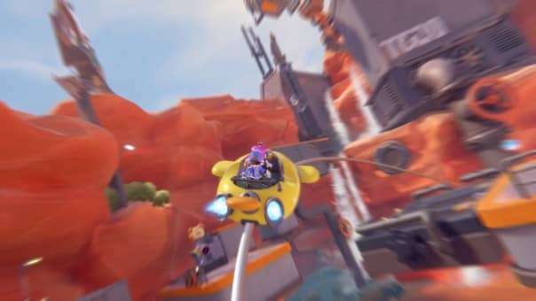 Two players ride a rollercoaster-like vehicle in POPUCOM, speeding toward a new vibrant world full of adventure.