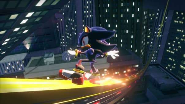 A slick moment from the SONIC X SHADOW GENERATIONS review as Shadow the Hedgehog slides along a barrier through a neon-lit cityscape.