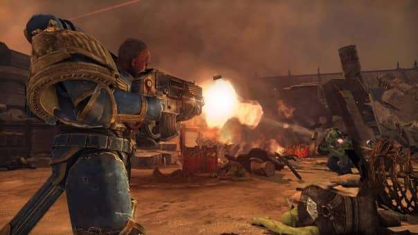 The Ultramarines captain fires at charging Orks in the Warhammer 40000: Space Marine Master Crafted Edition review, showcasing intense combat.
