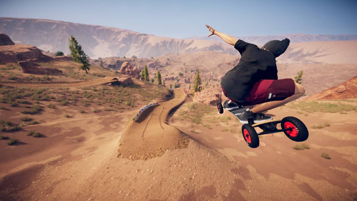 A mountainboarder soaring mid-air during a high-speed trick run in Descenders Next’s rugged rocky range