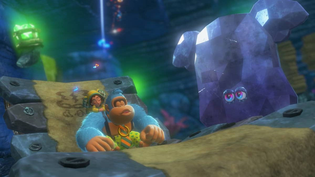 Donkey Kong Bananza features Green Kong and Pauline reacting to a mysterious talking rock deep inside a cavernous chamber.