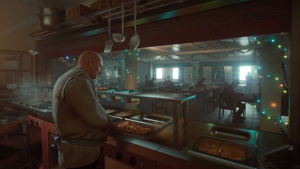 Roy serves meals in the canteen during a key moment explored in the review.