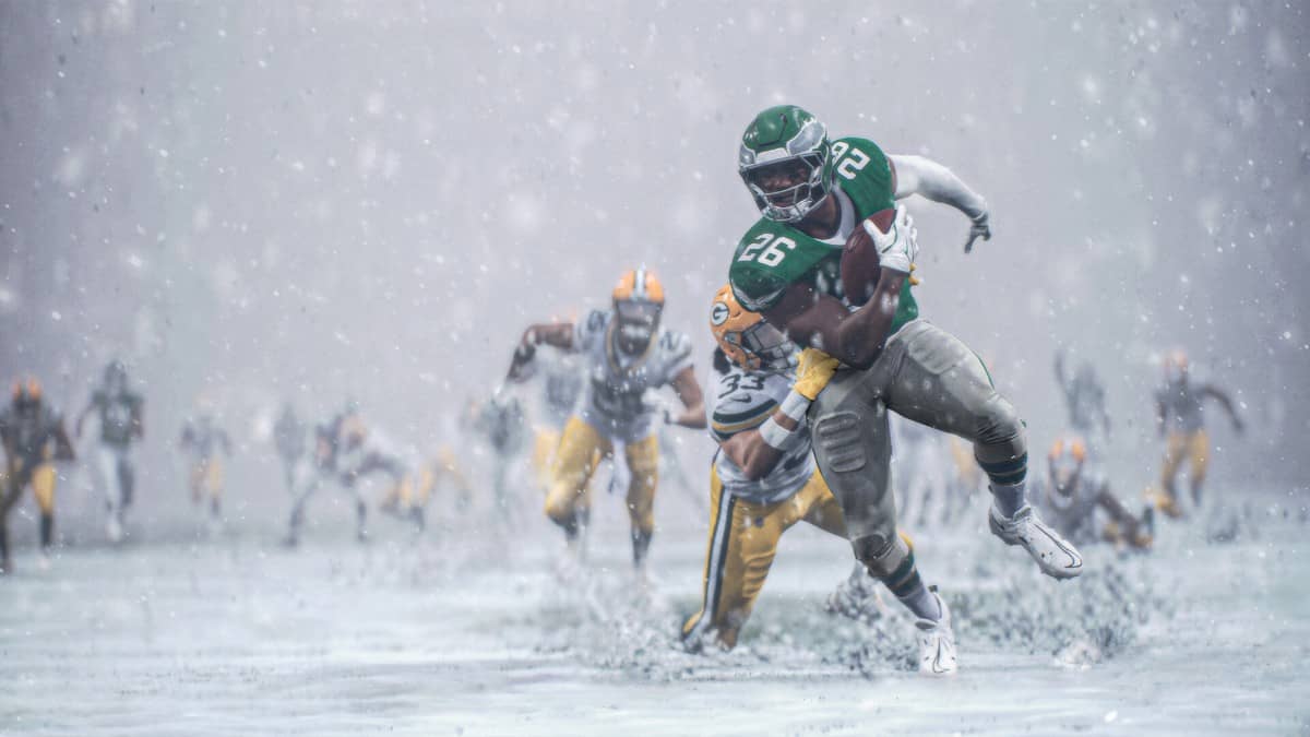Barkley powering through the snow in Madden NFL 26 with a defender clinging on at Lincoln Financial Field.