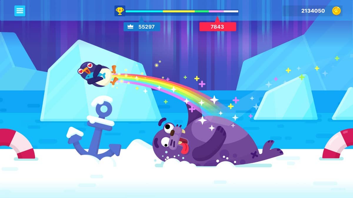 A penguin soars through snowy skies in Bouncemasters, leaving a vibrant rainbow trail behind mid-flight.