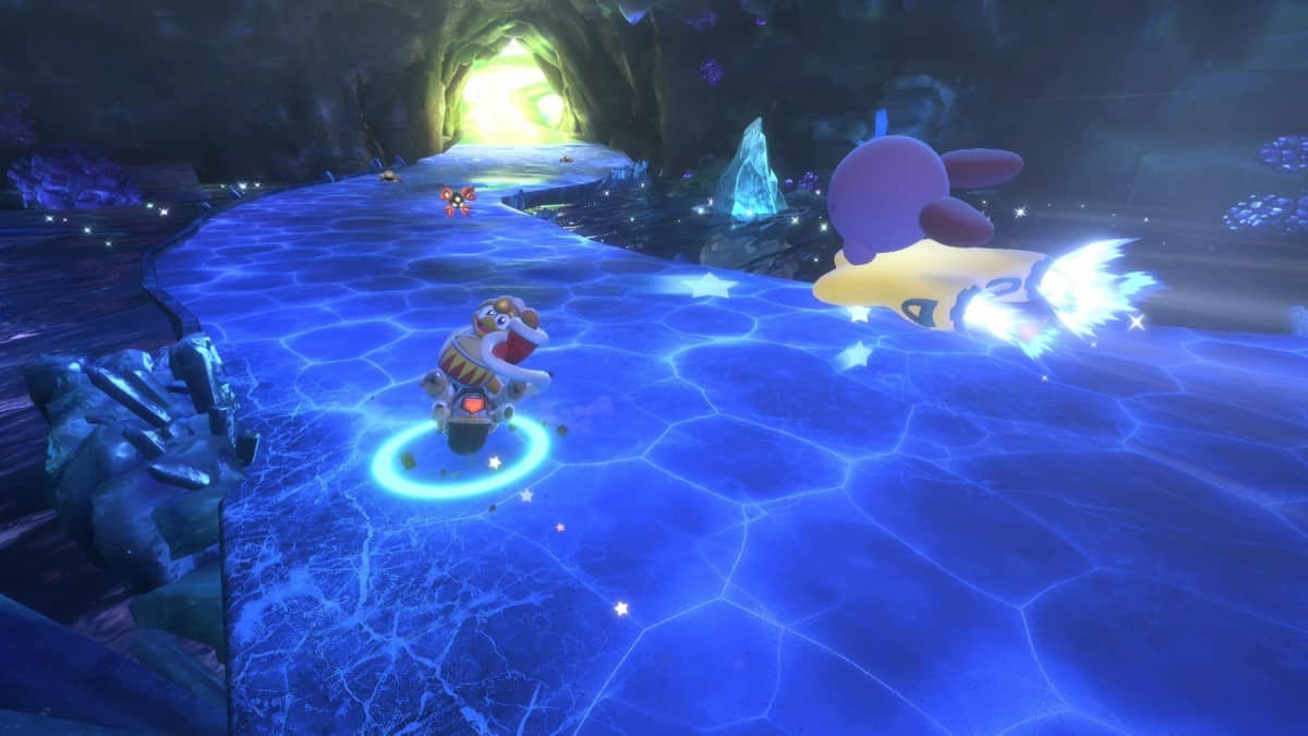 Kirby racing on a frozen track chasing King Dedede in Kirby Air Riders, showcasing thrilling icy gameplay.