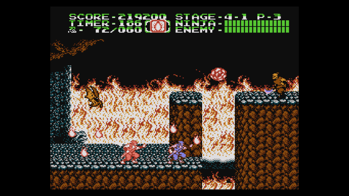Ryu advances toward an enemy with his shadow clone amid blazing flames in Console Archives Ninja Gaiden II: The Dark Sword of Chaos.