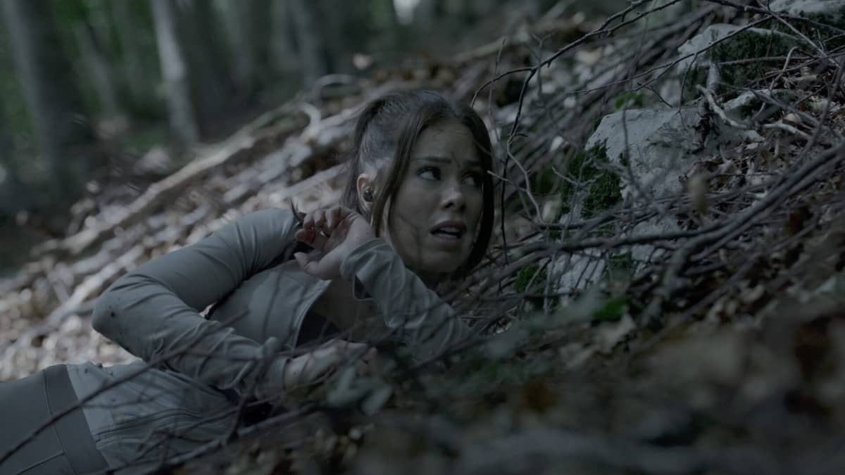 A frightened Zanna hides on a slope in The Run after falling and using the terrain to stay unseen.