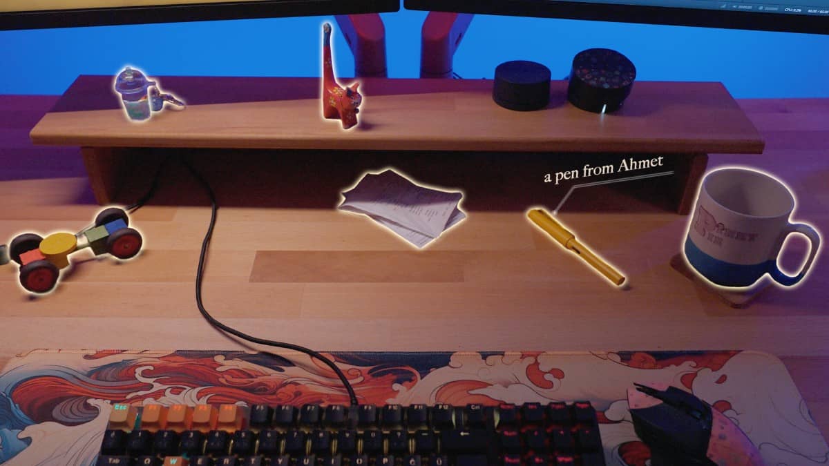 Interact with items like pens and cups on the table in Hacked: The Streamer via Gert Lush Gaming.