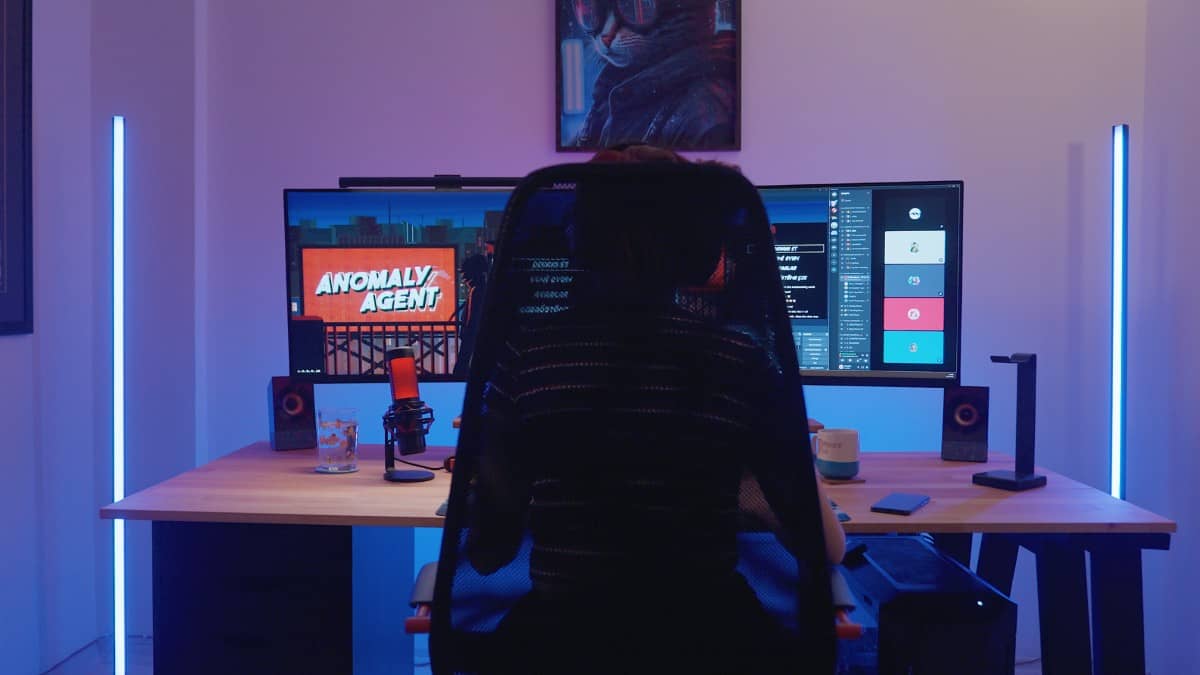 A view from behind the chair of Pinky Pie's desk setup featuring Anomaly Agent in Hacked: The Streamer by Gert Lush Gaming.