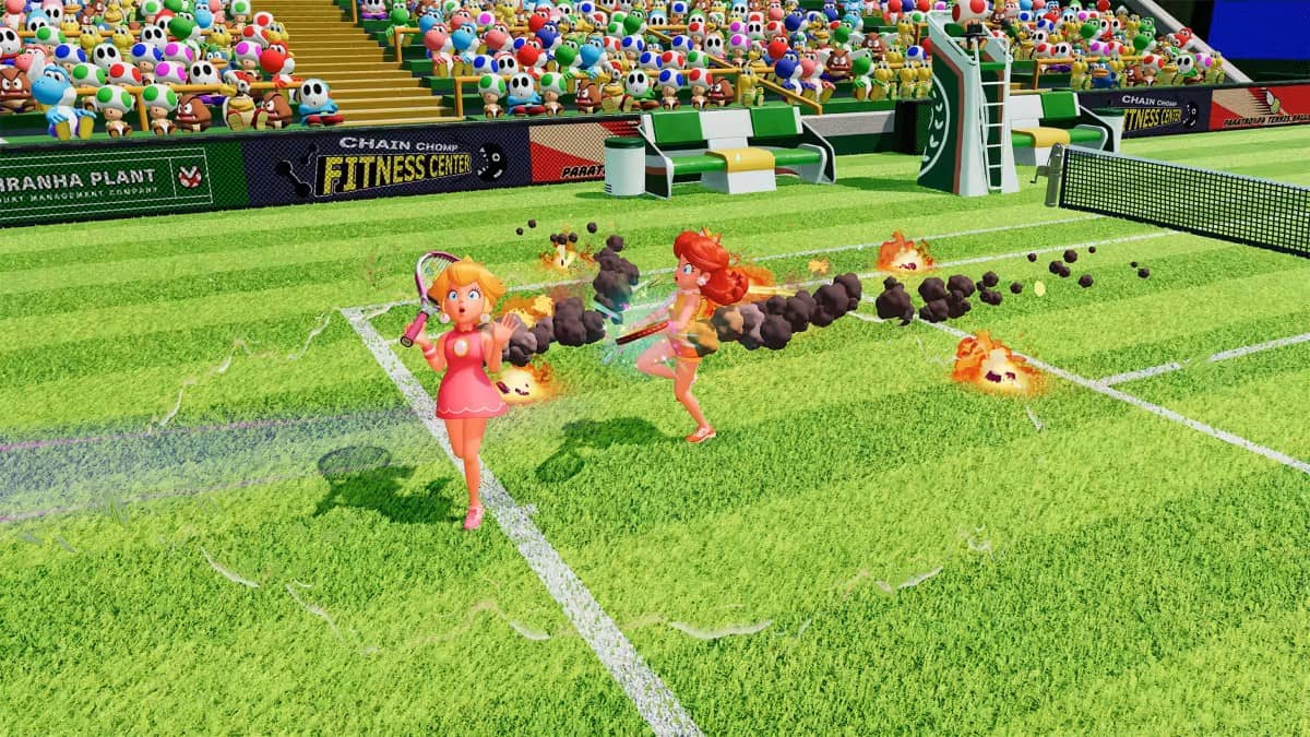 Princess Peach and her twin scramble to extinguish flames after a fiery shot in Mario Tennis Fever on Gert Lush Gaming.