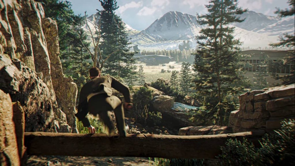 Bond leaps over a log while scaling a mountain to infiltrate a enemy base in 007 First Light.