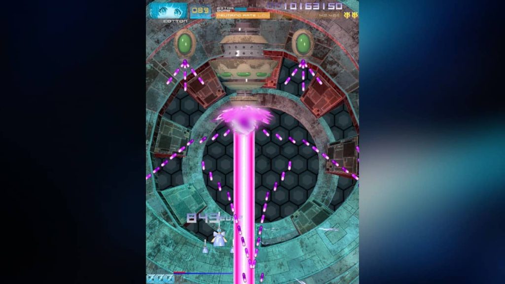 A massive pink laser fires at the player, showcasing the arcade presentation of Psyvariar 3 Switch 2 Edition.