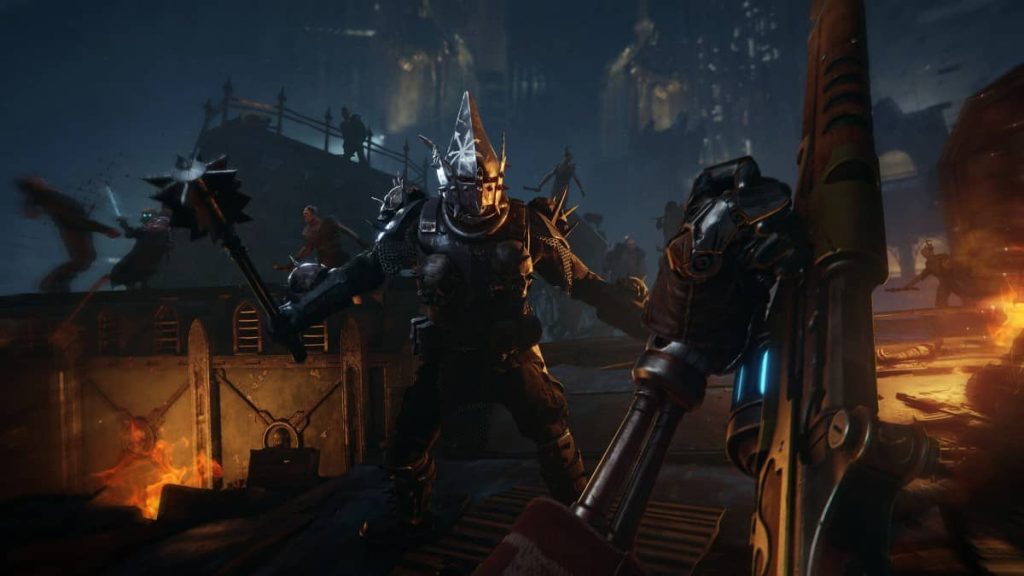 A Skitarii survives an area full of fire and chaotic enemies in the Gert Lush Gaming review of Warhammer 40k Darktide.